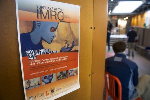 View of IMRC Center Commons space with poster for movie night event.