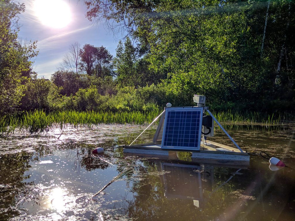 floating pond station art work with solar panels floating on water/pond