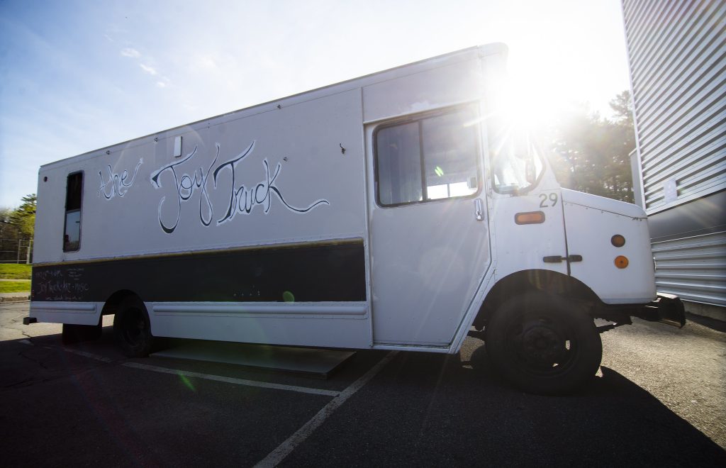 Side view of the converted bread truck now known as the "Joy Truck" parked
