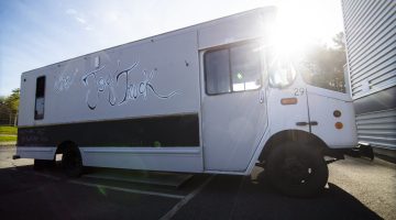 Side view of the converted bread truck now known as the "Joy Truck" parked