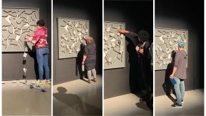 a collage of 4 images in a row showing 4 different people moving pieces in a large sliding board artwork mounted onto the wall